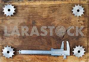 Different construction tools on a wooden background - screwdriver, caliper.