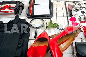 Women clothing set and accessories on white wooden background.