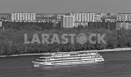 Modern ship on the Dnieper River in Kiev, on the background of the residential area Berezniaky