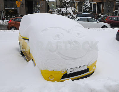Yellow car under the snow