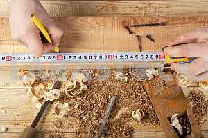 Carpenter tools on wooden table with sawdust. Circular Saw.