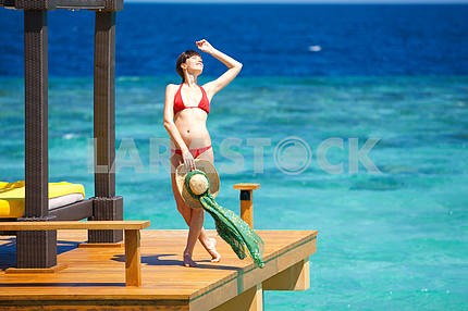 Beautiful girl in bikini onbackground of ocean