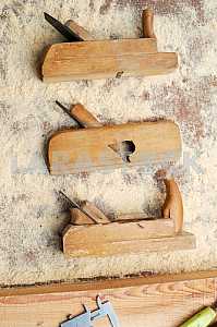 Different construction tools on a wooden background - screwdriver, caliper.