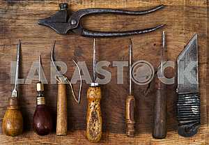 Different construction tools on a wooden background - screwdriver, caliper.