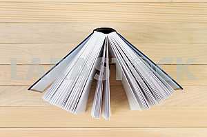 Stack of hardback books on wooden table. Back to school. Copy space