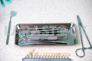 Stomatological instrument in the dentists clinic. Operation, tooth replacement.