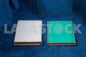 Open book, stack of hardback books on wooden table. Back to school. Copy space