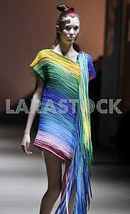 Model in the colored dress demonstrates outfit by Ukrainian designer Sistan Varvara