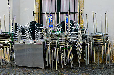 Folding chairs and tables of a street cafe