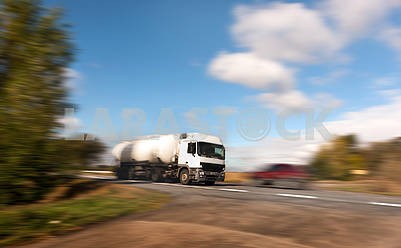 A white tanker on a country road