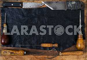 Different construction tools on a wooden background - screwdriver, caliper.