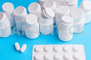 Many pills and tablets isolated on light blue background