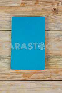 Open book, stack of hardback books on wooden table. Back to school. Copy space