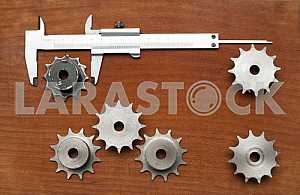 Different construction tools on a wooden background - screwdriver, caliper.