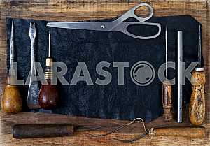 Different construction tools on a wooden background - screwdriver, caliper.