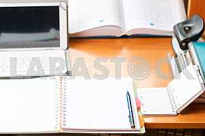 Stack of hardback books on wooden table. Back to school. Copy space. Top view