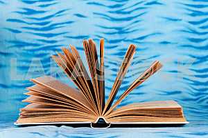 Old and used hardback books or text books on wooden table. Books and reading are essential for self improvement, gaining knowledge and success in our careers, business and personal lives. Copy space
