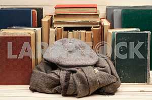 On a wooden table books, documents, calculator, red briefcase.