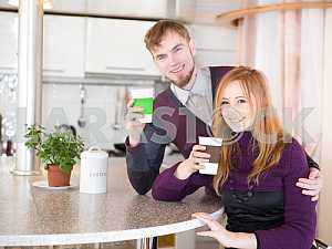 Young happy couple drinking tea in the morning
