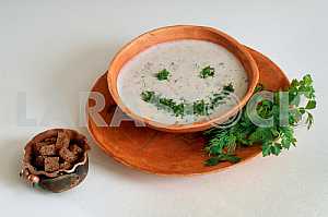 Creamy soup with spices on a light background