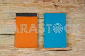Open book, stack of hardback books on wooden table. Back to school. Copy space