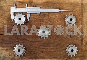 Different construction tools on a wooden background - screwdriver, caliper.