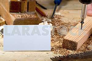 Carpenter tools on wooden table with sawdust. Circular Saw.