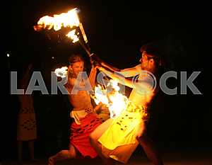 Artists juggle flaming maces