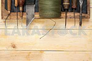 Carpenter tools on wooden table with sawdust. Circular Saw.