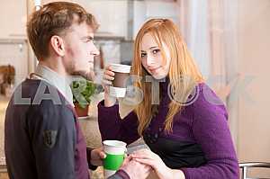 Young happy couple drinking tea in the morning