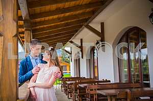 Bride and groom at wedding Day walking Outdoors on spring nature. Bridal couple, Couple in love bride and groom posing near wooden bench in gazebo in their wedding day