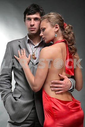 Portrait of a young beautiful couple. Young woman embraces man.