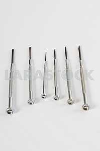 Different construction tools on a wooden background - screwdriver, caliper.