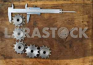 Different construction tools on a wooden background - screwdriver, caliper.