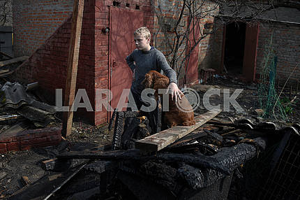 A boy with a dog at the conflagration in Balaklei