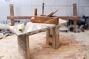 Different construction tools on a wooden background - screwdriver, caliper.