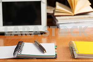 Stack of hardback books on wooden table. Back to school. Copy space. Top view