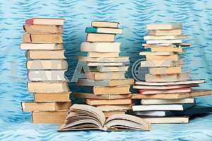 Old and used hardback books or text books on wooden table. Books and reading are essential for self improvement, gaining knowledge and success in our careers, business and personal lives. Copy space