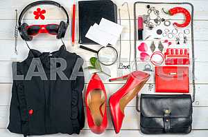 Women clothing set and accessories on white wooden background.