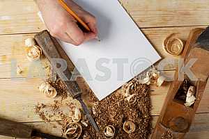 Carpenter tools on wooden table with sawdust. Circular Saw.
