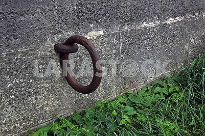 The large rusty metal ring for mooring