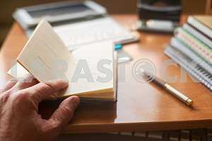 Stack of hardback books on wooden table. Back to school. Copy space. Top view