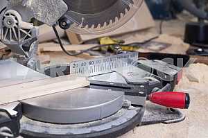 Different construction tools on a wooden background - screwdriver, caliper.