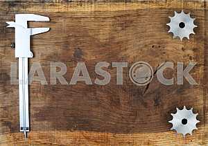 Different construction tools on a wooden background - screwdriver, caliper.