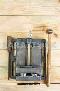 Different construction tools on a wooden background - screwdriver, caliper.