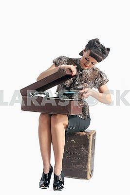 beautiful girl and old gramophone, on white background in studio