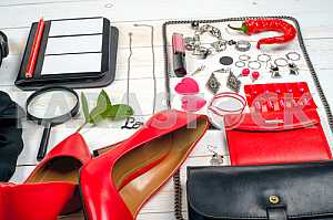 Women clothing set and accessories on white wooden background.