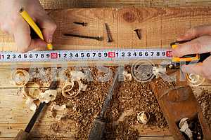 Carpenter tools on wooden table with sawdust. Circular Saw.