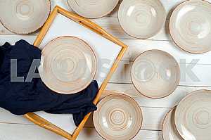 Blank white dish on a wood background.