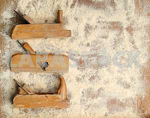Different construction tools on a wooden background - screwdriver, caliper.